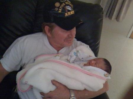 ME HOLDING MY FIRST BORN GRANDDAUGHTER