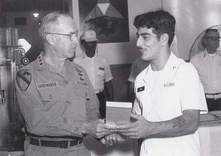 PVT JOHN STIO RECEIVING BEST COOK AWARD