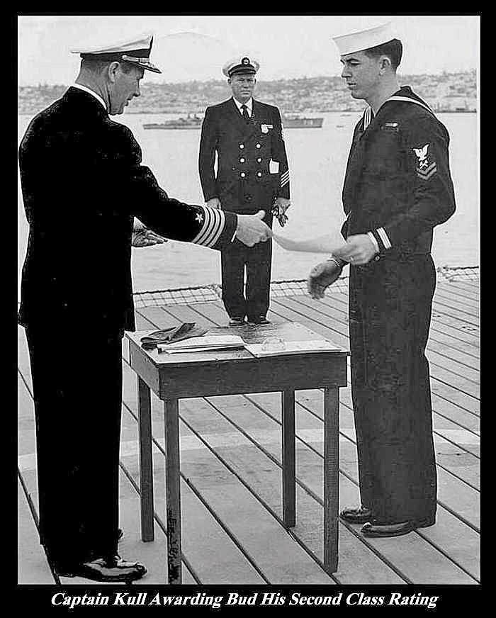 Captain Kull awarding Charles Norris his second class rating.