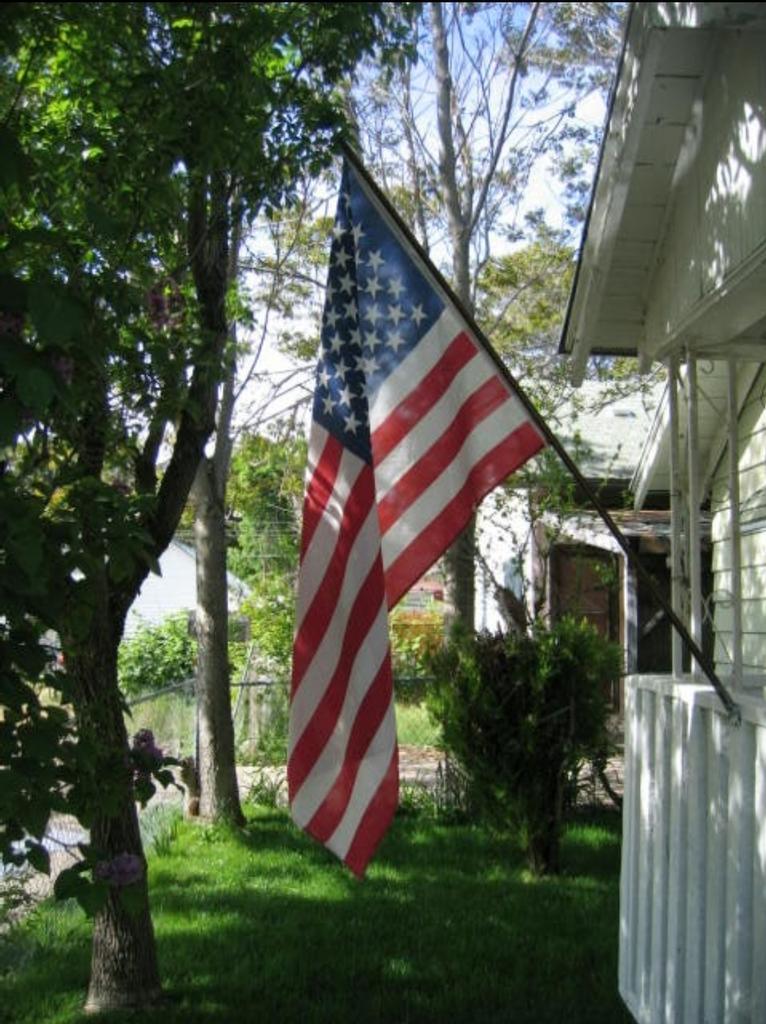 Lynn Chapman in front of dispatch shack sign